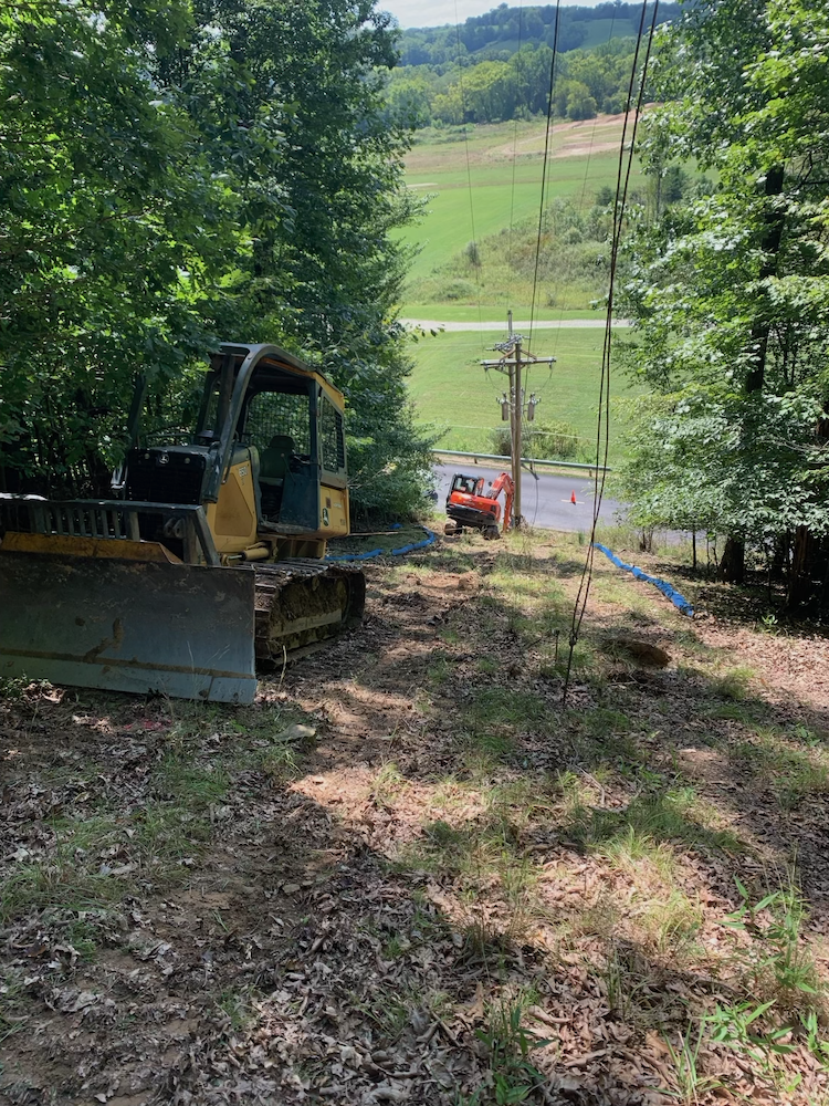 Treton Excavating on a hill with Kubota Mini